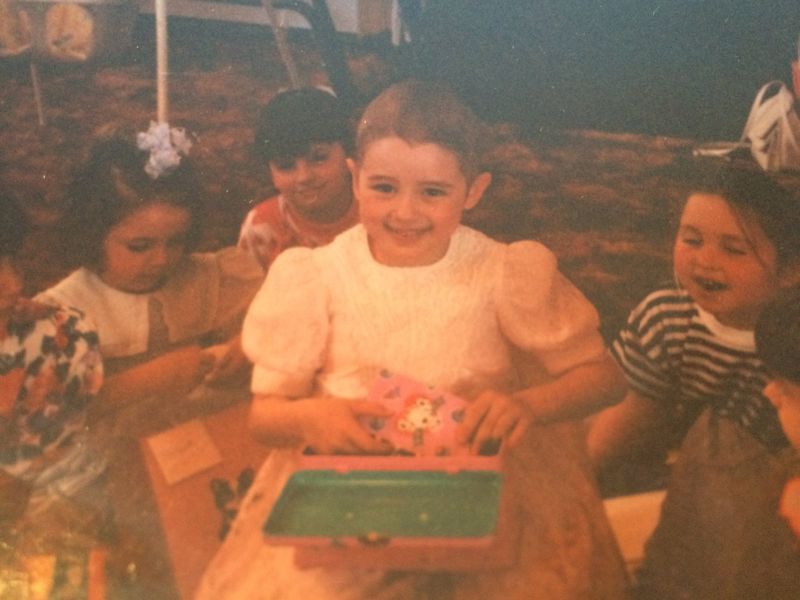 Danielle as a child during treatment, smiling at a party with friends